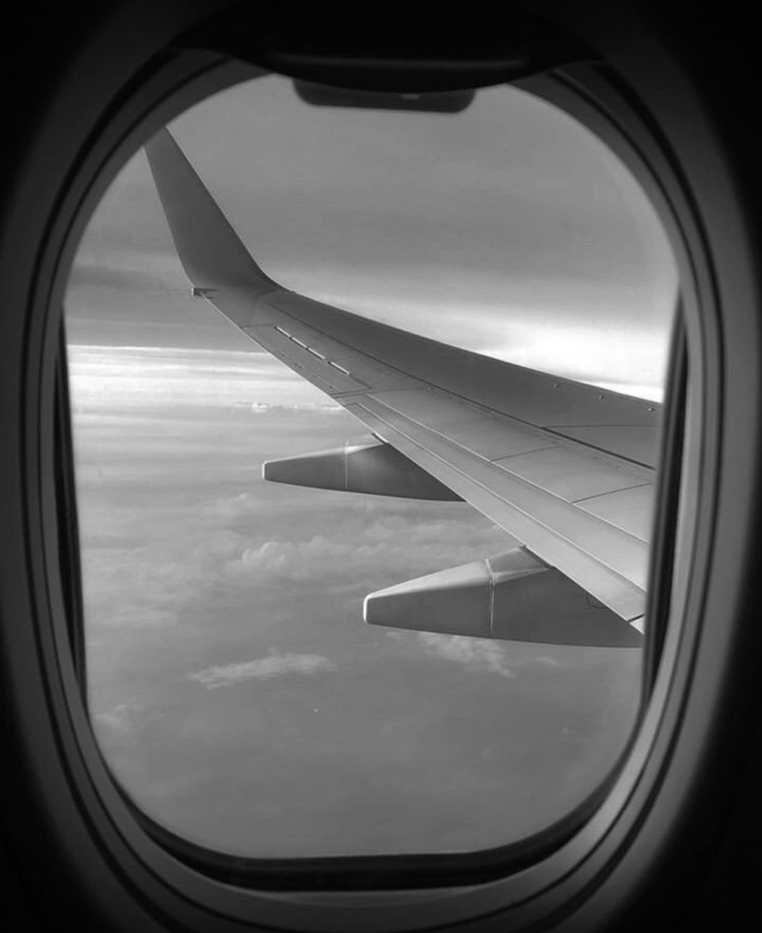 Blog poster sharing the view through an airplane window of the clouds.
